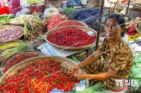 A Woman Is Sorting Chili Peppers On A Market In Hue Central Vietnam