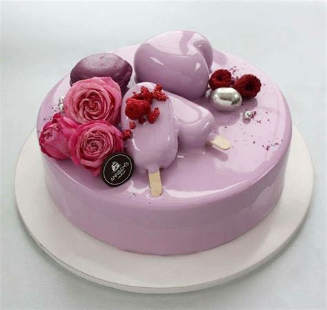 A Cake With Pink Frosting And Flowers On Top