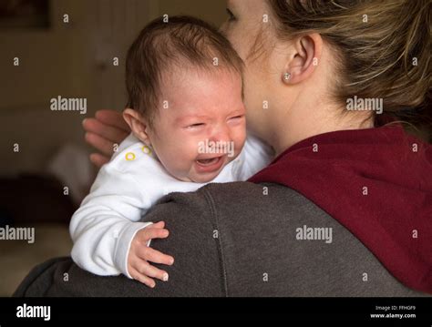 Baby Girl Crying On Mums Shoulder Stock Photo Alamy