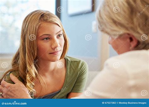 Doctor Treating Teenage Girl Suffering With Depression Stock Photo