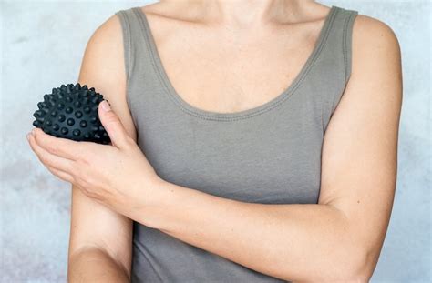 Premium Photo A Woman Massages Her Arm With Spiky Trigger Point Ball