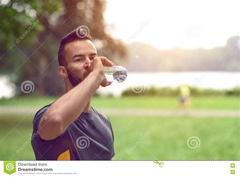 Young Man Drinking Bottled Water Stock Photo Image Of