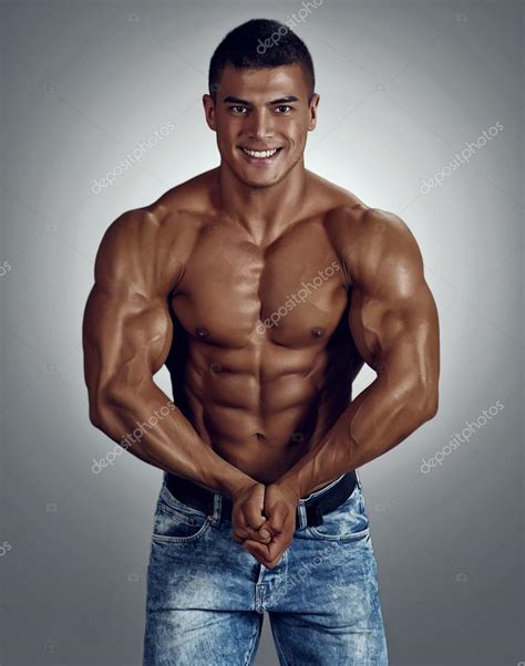 Smiling Muscular Male Model In Blue Jeans Stock Photo Alexmbronco