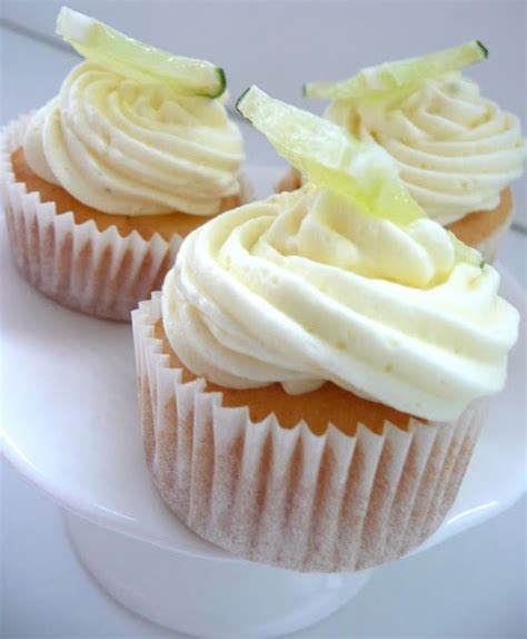 Three Cupcakes With White Frosting On A Plate
