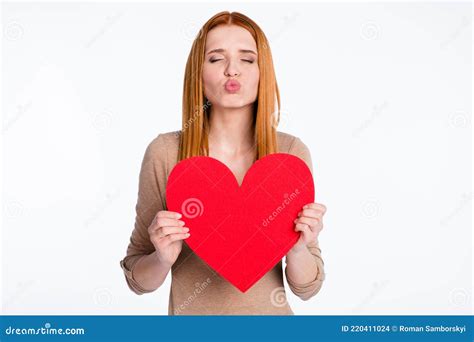 Photo Of Flirty Sweet Ginger Lady Wear Beige Shirt Sending Kiss Holding Big Paper Heart Isolated
