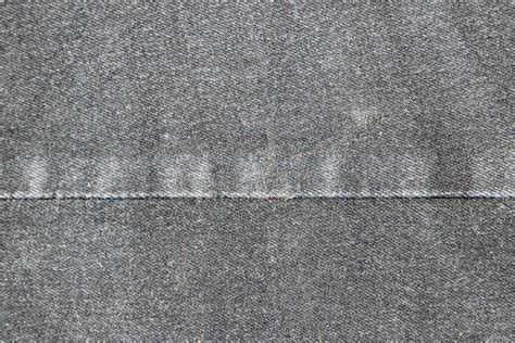 Texture Of A Gray Denim Fabric Two Pieces Of Fabric Stitched Together