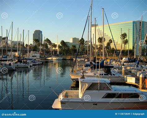 Yachts Sailboats And Speedboats Docked By Shoreline Village Rainbow