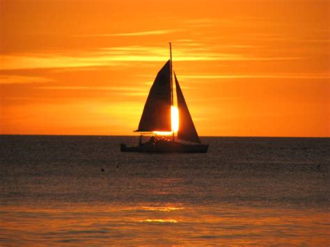 Sailboat Photography | sailboat sails in front of the sunset off Coquina Beach on southern ...