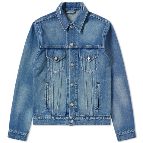 Balenciaga's blue jacket is made from japanese denim that's revered for its premium quality and traditional construction methods of using shuttle looms. Balenciaga Wave Logo Denim Jacket Balenciaga