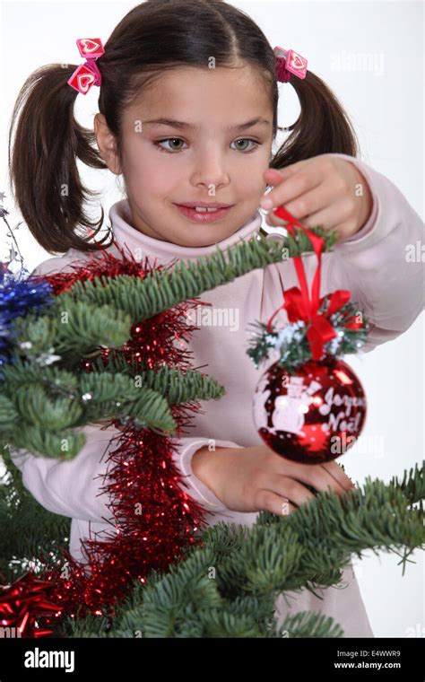 Young Girl Decorating A Christmas Tree Stock Photo Alamy