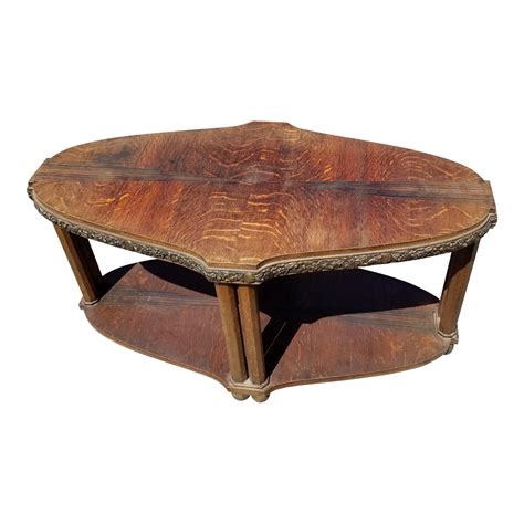 The elliptical top size is 60 wide x 80 long with a total height of 22 the shape of the base is an art nouveau. Art Nouveau Coffee Table With Brass Detail | Chairish