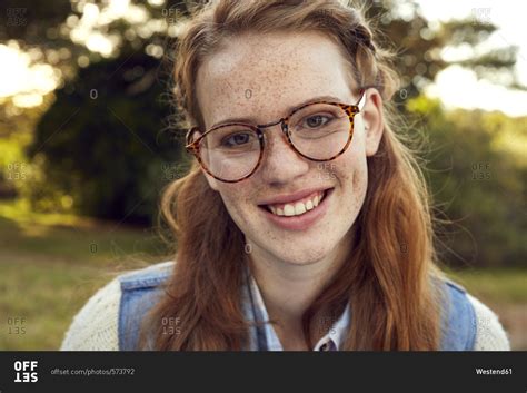 Portrait Of Redheaded Young Woman With Freckles Wearing Glasses Stock