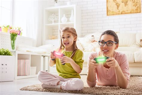 Mother And Daughter Playing Video Games Together Stock Photo Free Download