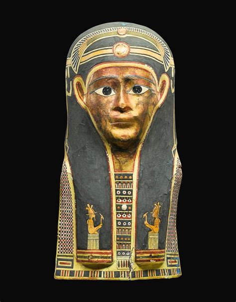 An Egyptian Polychrome And Gilt Cartonnage Mummy Mask Late