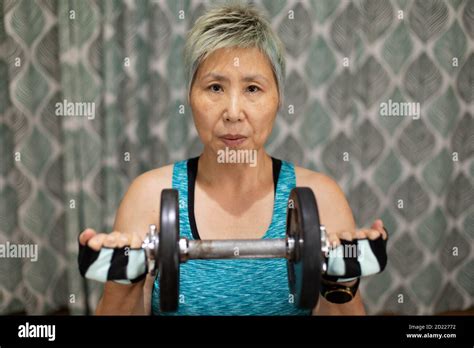 Fit Mature Taiwanese Woman Of Chinese Ethnicity Exercises Alone In Her Home To Avoid Crowds