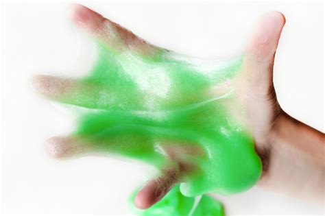 Premium Photo Hand Playing With Textured Slime With Bubbles