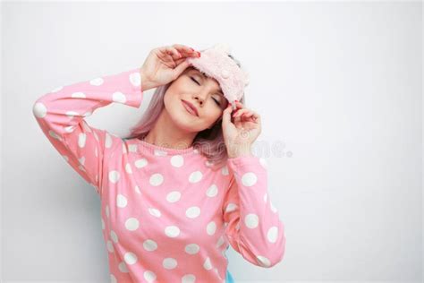 Beautiful Young Blonde In Pink Pajamas And A Sleep Mask Stock Image