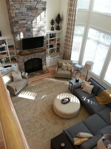 The fireplace is the natural focal point of a living room. Sectional + round sofa/center piece. Like this arrangement ...