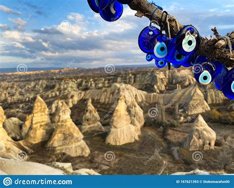 Nazar Amulets Hang On A Tree Against A Background Of A Valley Of Rocks