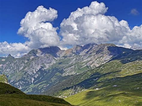 Picturesque And Beautiful Clouds Over The Swiss Mountain Peaks And In