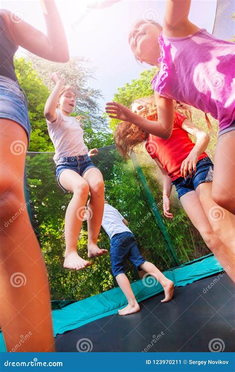 Happy Children Enjoying Jumping On The Trampoline Stock Image Image