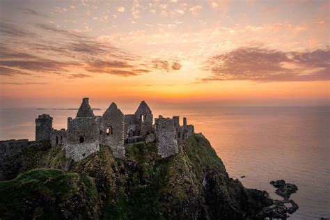 Download Dunluce Castle Ruin Northern Ireland Sunset Horizon Wallpaper