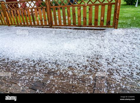 View At Wooden Terrace With Hail Stones During Hailstorm From Sky With