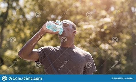 Black Man Drinking Water Suffering From Hot Weather Stock Photo