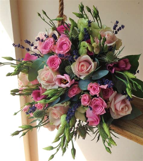 this bridal bouquet filled with different pink roses and lisianthus is made all the more