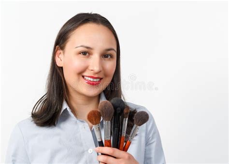 Young Woman Makeup Artist With A Set Of Makeup Brushes On A White