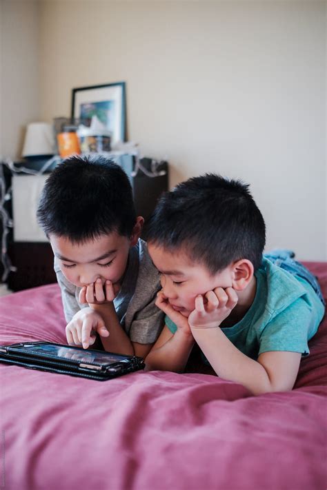 Asian Kids Playing Game On The Tablet Computer By Stocksy Contributor