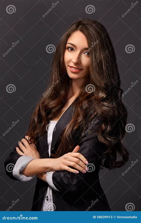 Portrait Of An Attractive Woman Standing With Her Arms Crossed Stock