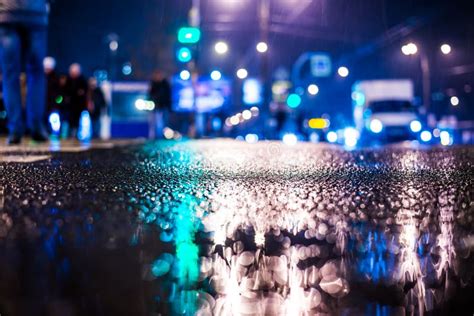 Rainy Night In The Big City Pedestrians Cross The Busy Intersection