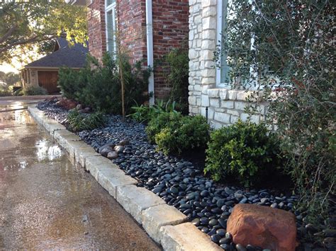 Here We Used River Rock Instead Of Mulch Makes For A Dramatic Look