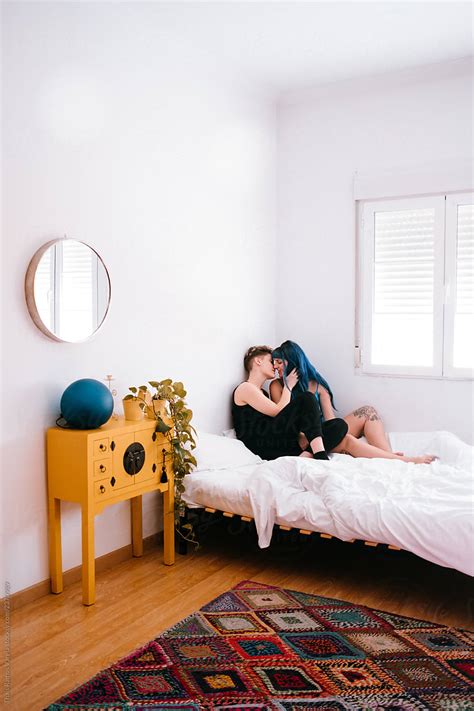Lesbian Couple Comfortable In Their Bright White Room By Stocksy Contributor Thais Ramos