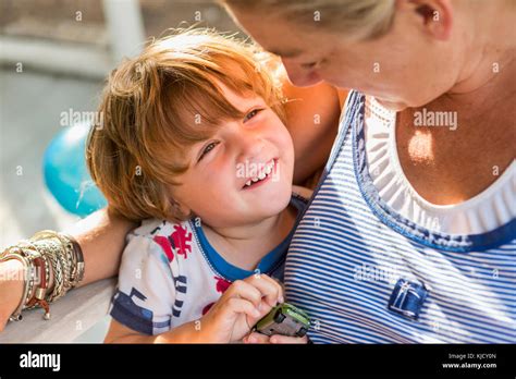Caucasian Mother Hugging Son Holding Toy Car Stock Photo Alamy