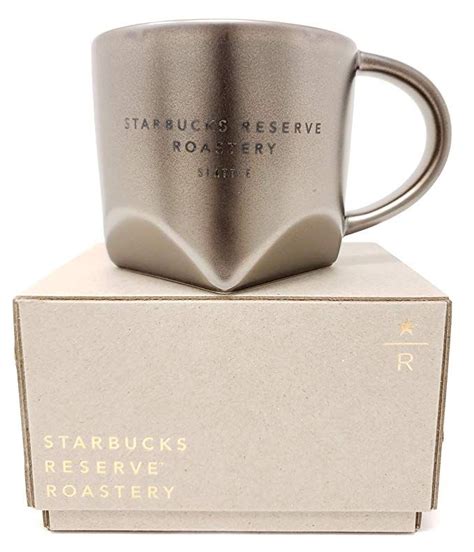 A Starbucks Mug Sitting On Top Of A Box