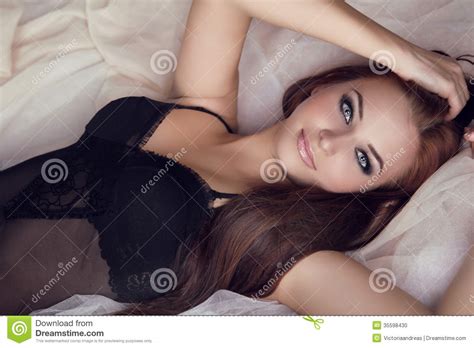 Fashion Portrait Of Beautiful Brunette Woman On Bed Stock