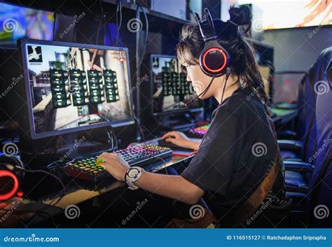 Young Teen Girl Playing Computer Games In Internet Cafe Stock Image