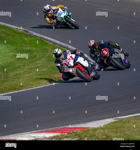 A Shot Of Several Racing Bikes Cornering On A Track Stock Photo Alamy
