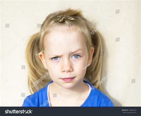 Portrait Of Little Girl With One Eyebrow Up Stock Photo 160909433