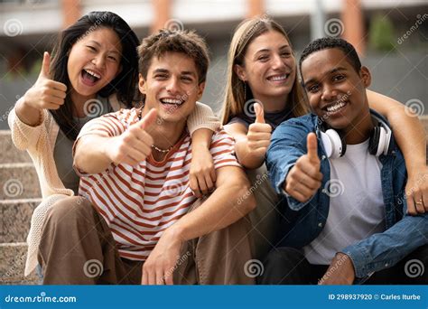 Cheerful Multicultural Group Of Friends Showing Thumbs Up Sitting On
