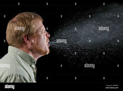 A Sneeze In Progress Revealing Plume Salivary Droplets As They Are