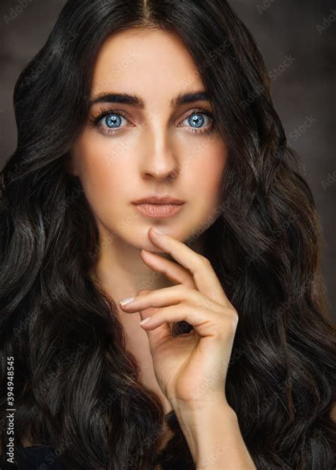 Brunette Girl With Long And Shiny Wavy Hair And Big Blue Eyes Beautiful Model With Curly