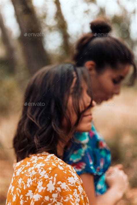Two Young Lesbians Caressing Each Other Walking In The Woods Stock
