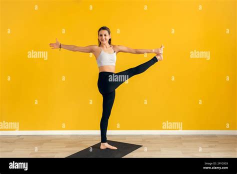 Young Woman Standing In Yoga Asana Utthita Hasta Padangusthasana