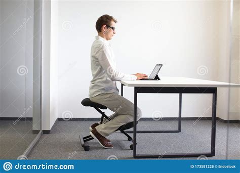 Correct Sitting Position At Workstation Man On Chair Working With