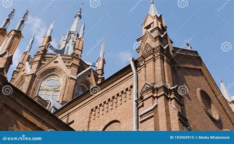 Red Brick Gothic Church On Background Blue Sky Action Bottom View Of