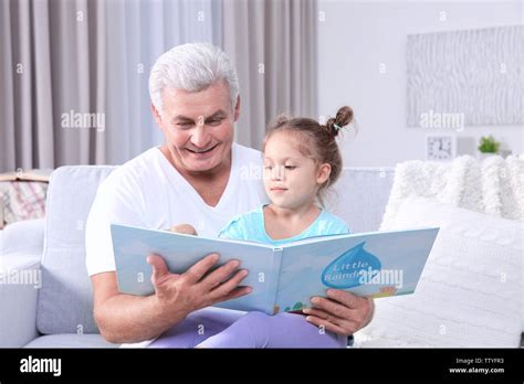Grandfather Reading His Granddaughter Book Stock Photo Alamy