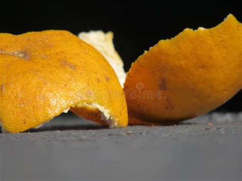 Orange Peels Atop A Gray Surface Against A Dark Background Stock Photo
